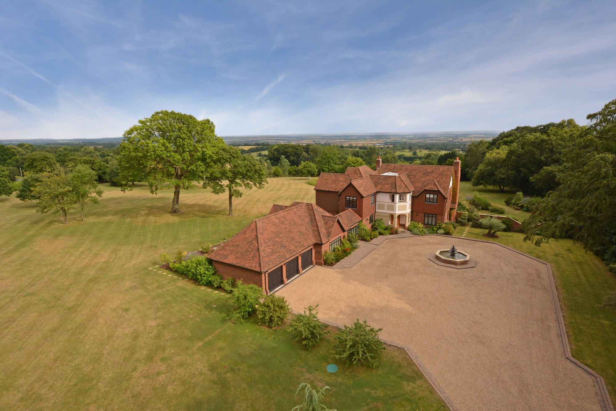 Country mansion from the air, lawns and a long drive